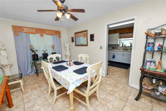 a dining room with furniture and a window