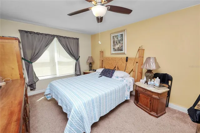 a bedroom with a bed dresser and window