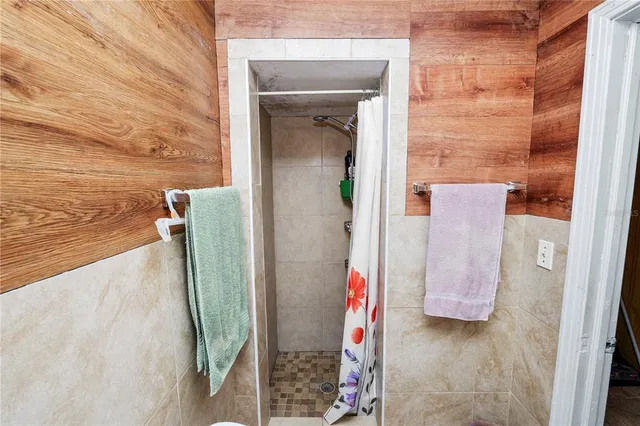 a bedroom with a bed and a flat screen tv in it