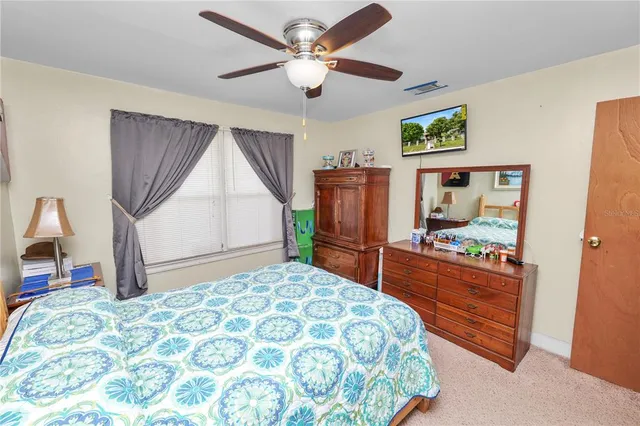a bedroom with bed and a chandelier