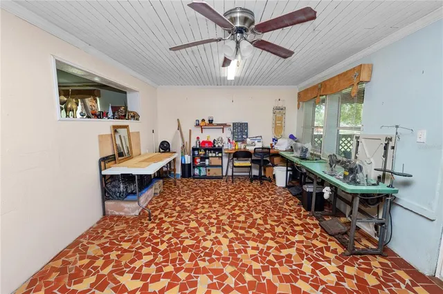 a living room with furniture a clock and a bookshelf