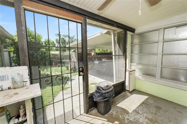 an aerial view of residential houses with outdoor space and trees