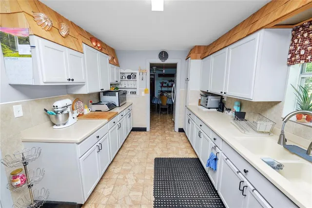 a kitchen with stainless steel appliances a refrigerator sink and cabinets