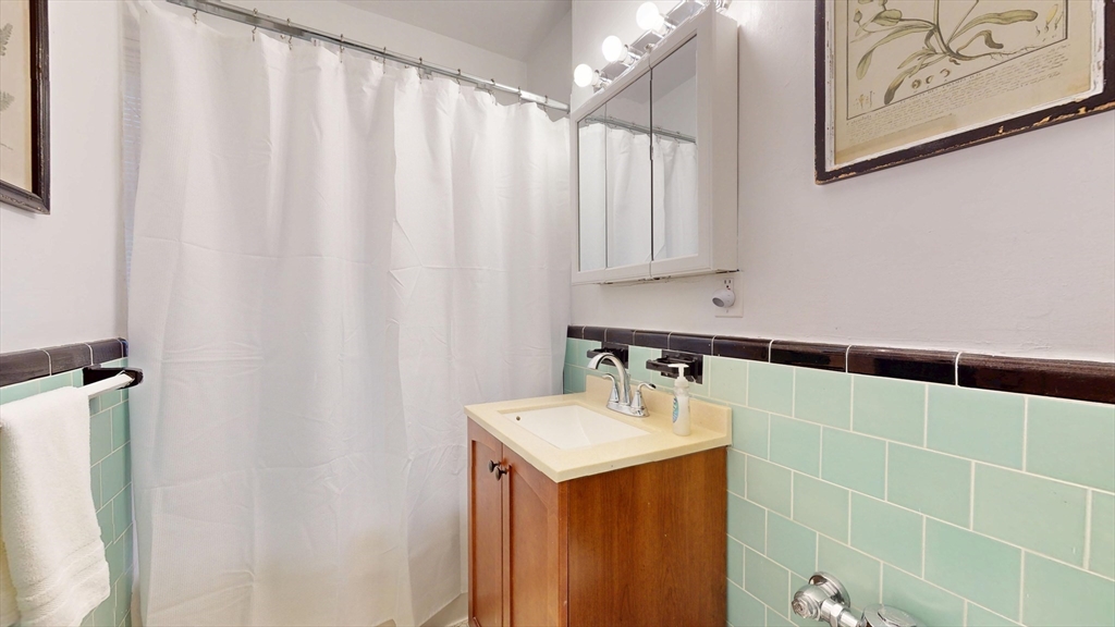 90 Kilsyth Road, Unit 44A Boston, MA 02135 - Photo 8 of 9 a bathroom with a sink and a mirror