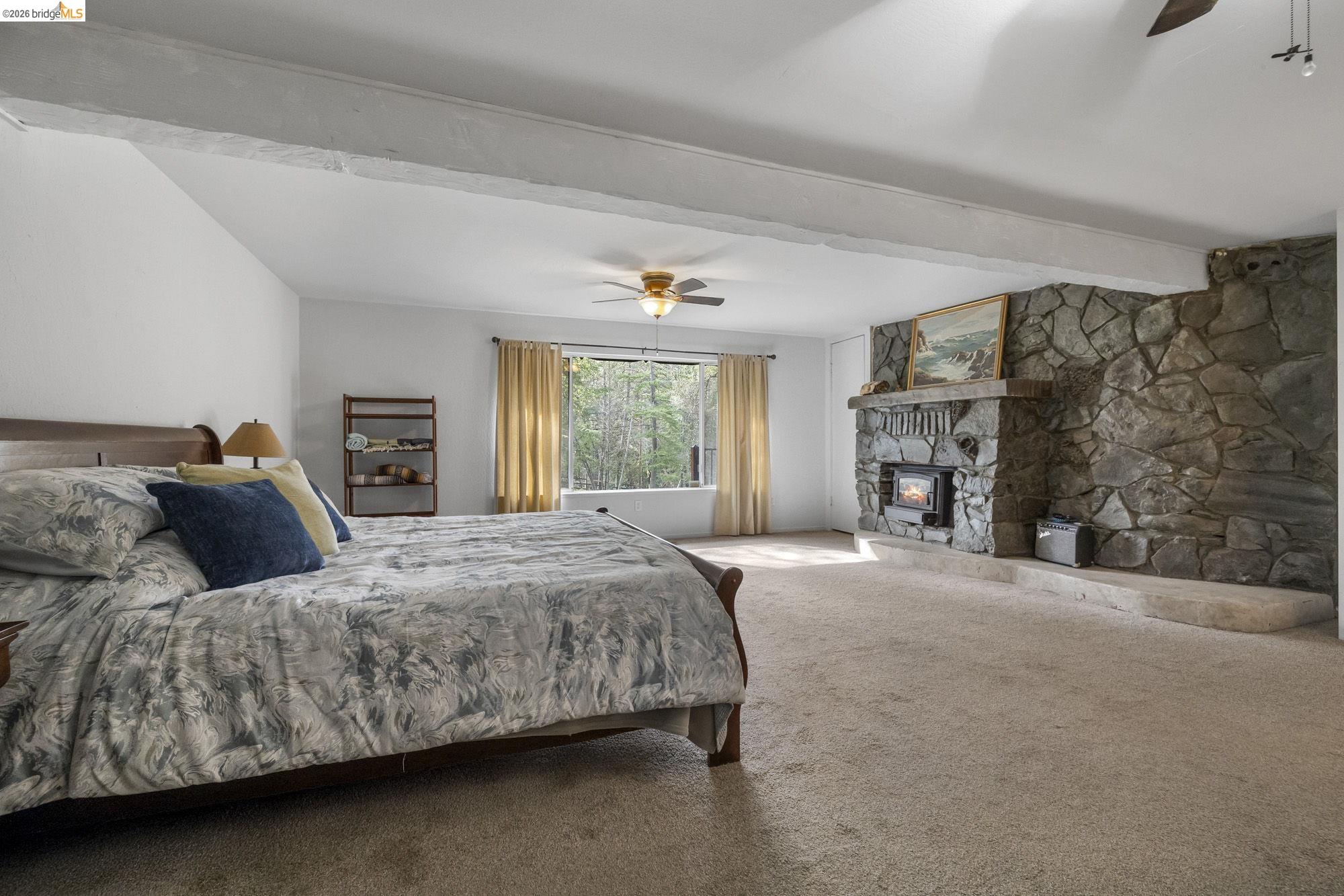 21550 Phoenix Lake Road Sonora, CA 95370 - Photo 19 of 50 a bedroom with a bed and a fireplace