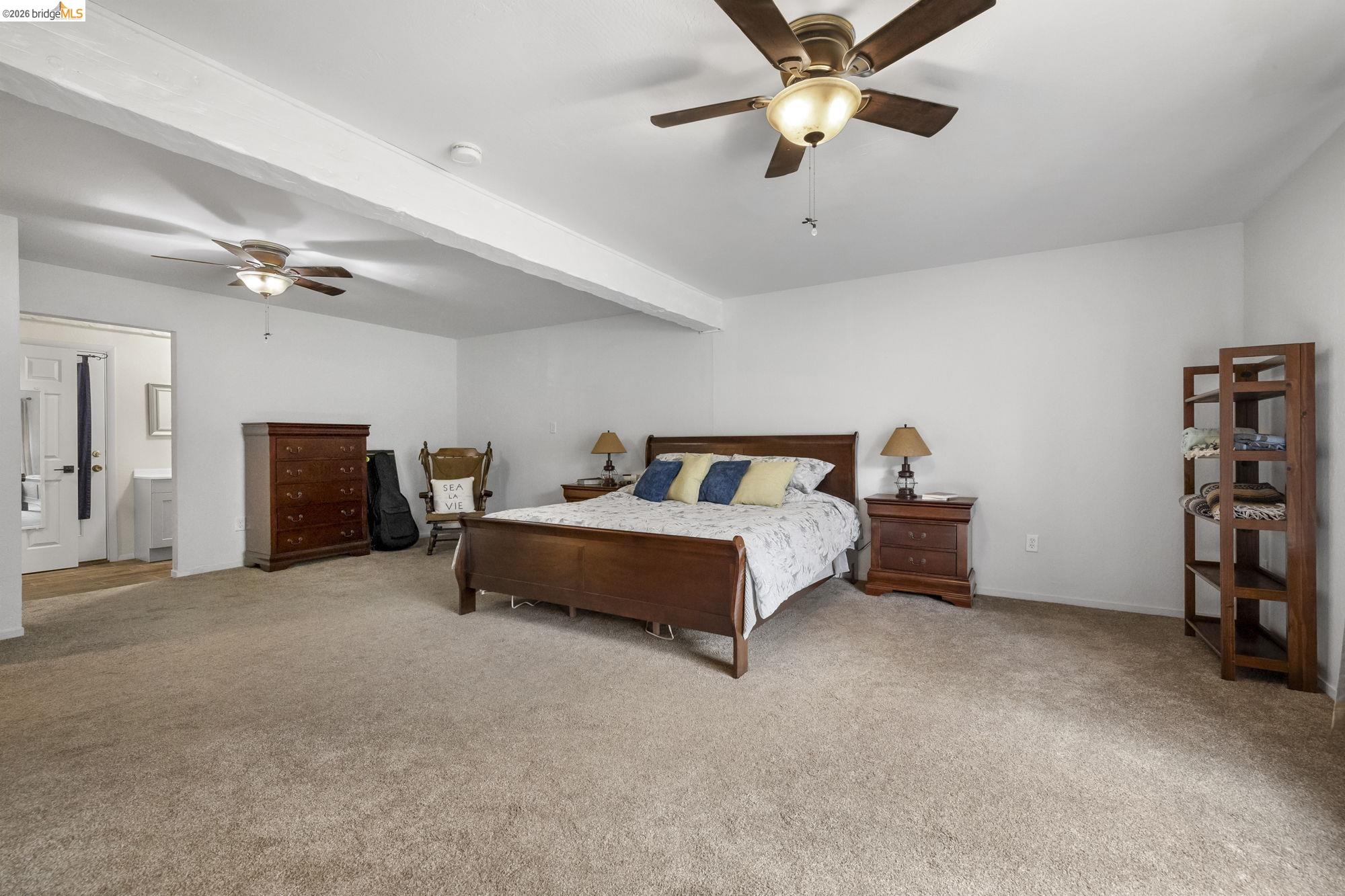 21550 Phoenix Lake Road Sonora, CA 95370 - Photo 21 of 50 a spacious bedroom with a bed and a ceiling fan