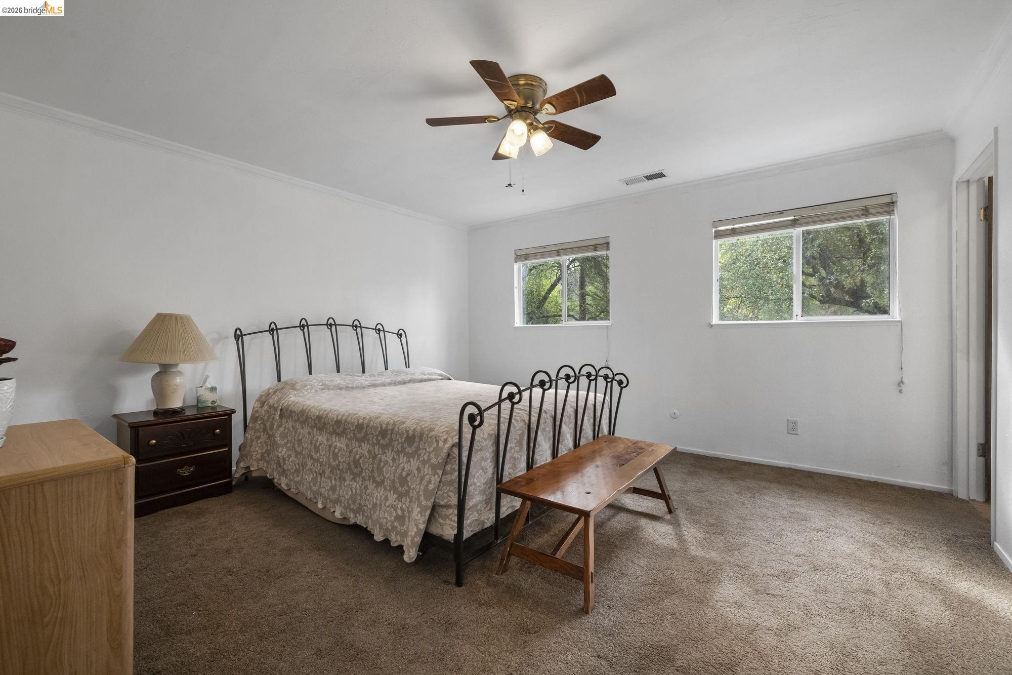 21550 Phoenix Lake Road Sonora, CA 95370 - Photo 26 of 50 a bedroom with a bed and a chandelier
