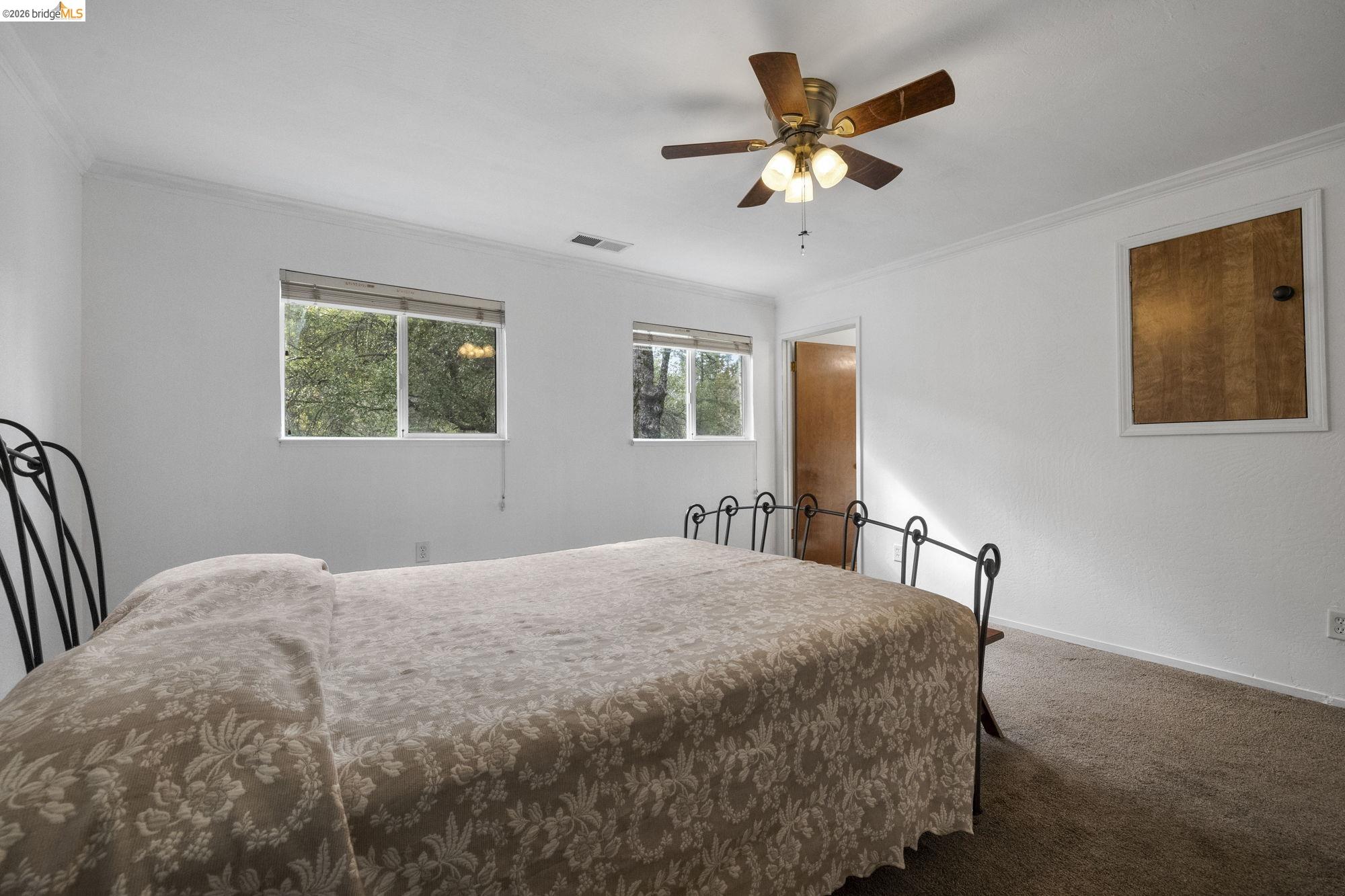 21550 Phoenix Lake Road Sonora, CA 95370 - Photo 27 of 50 a bedroom with a bed and window