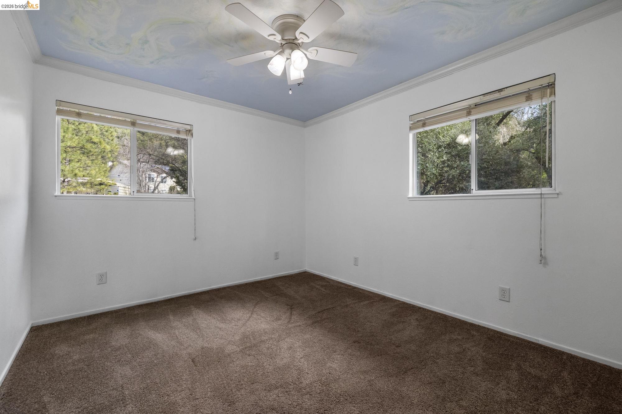 21550 Phoenix Lake Road Sonora, CA 95370 - Photo 29 of 50 en empty room with windows and ceiling fan