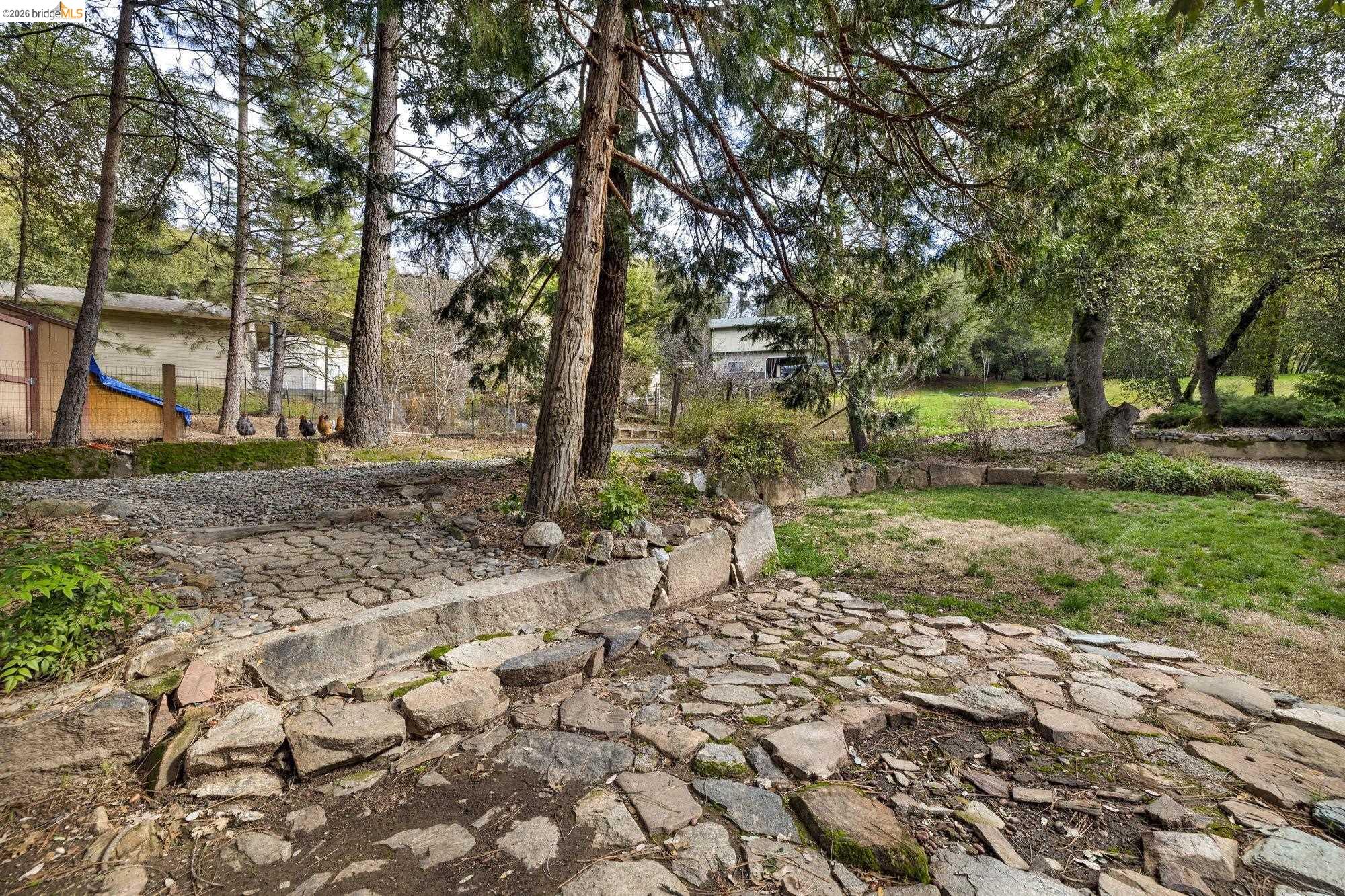 21550 Phoenix Lake Road Sonora, CA 95370 - Photo 36 of 50 a backyard of a house with lots of green space