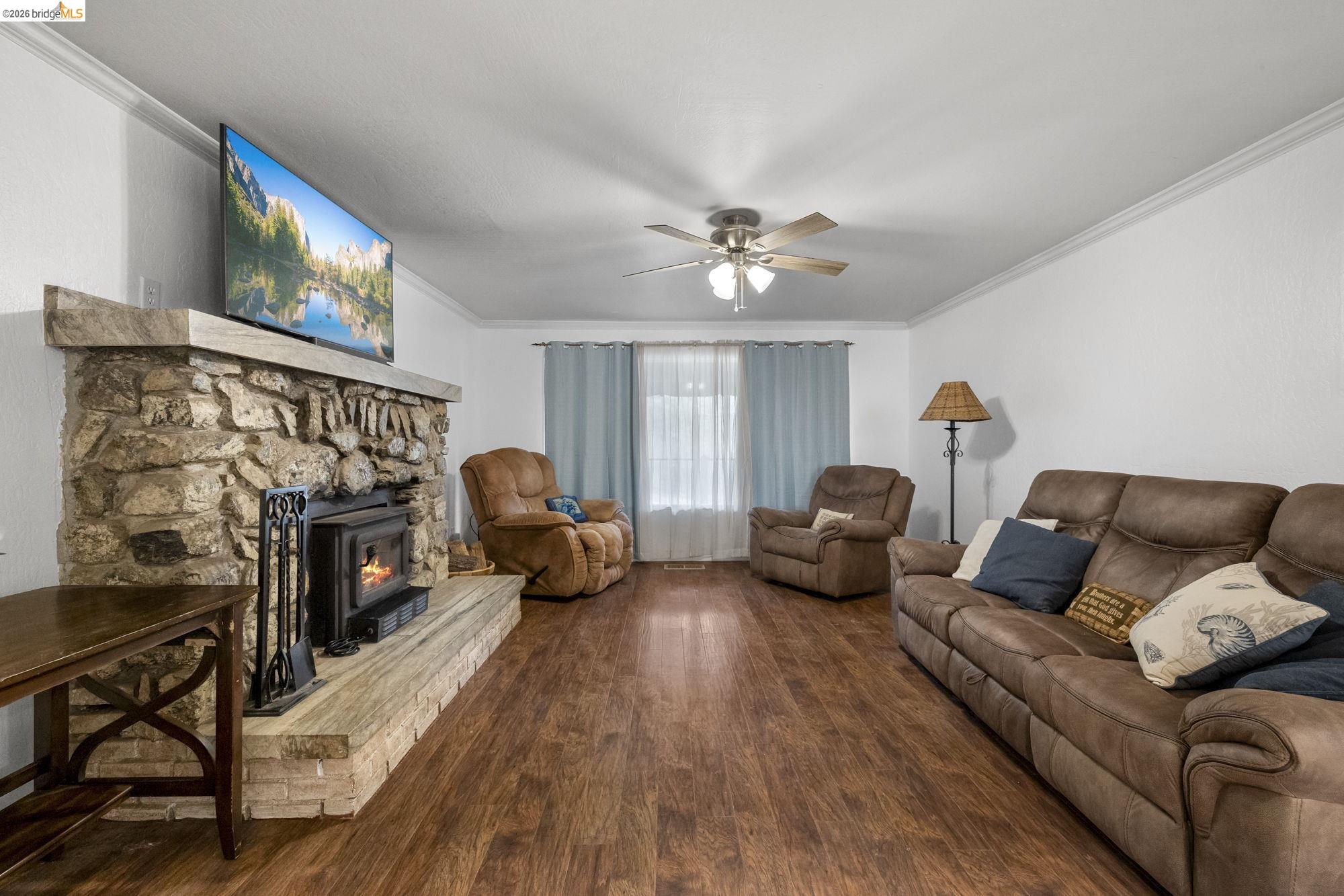 21550 Phoenix Lake Road Sonora, CA 95370 - Photo 4 of 50 a living room with furniture a fireplace and a flat screen tv
