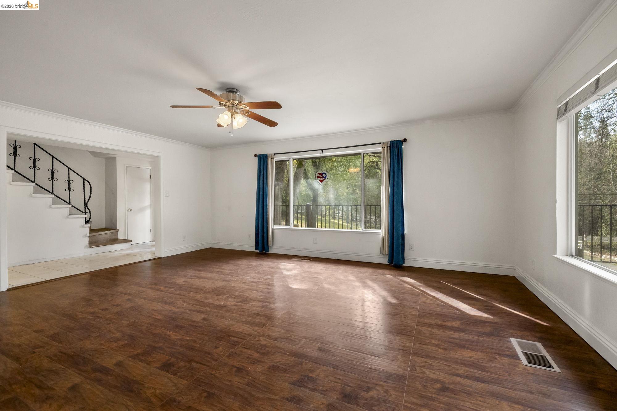 21550 Phoenix Lake Road Sonora, CA 95370 - Photo 8 of 50 a view of an empty room with a window and wooden floor