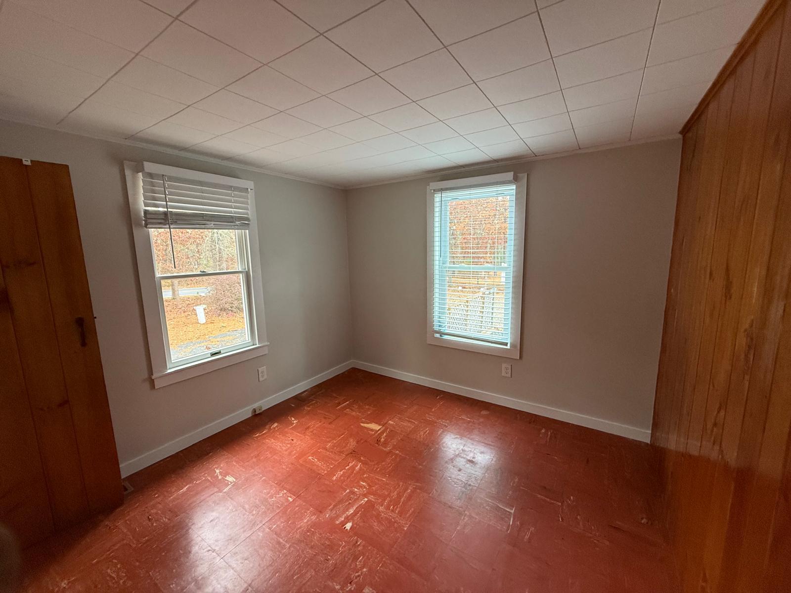 86 Lowell Road Mashpee, MA 02649 - Photo 17 of 18 an empty room with wooden floor and windows
