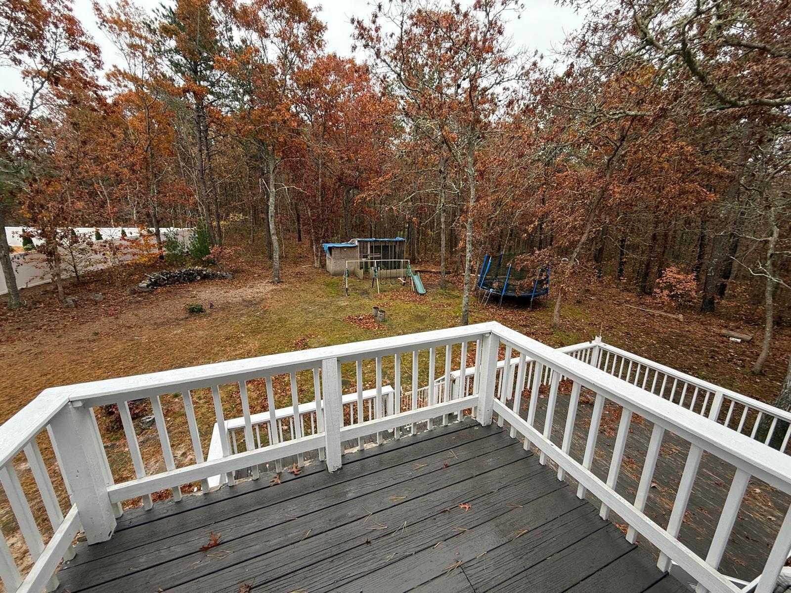 86 Lowell Road Mashpee, MA 02649 - Photo 4 of 18 a view of wooden deck and a yard