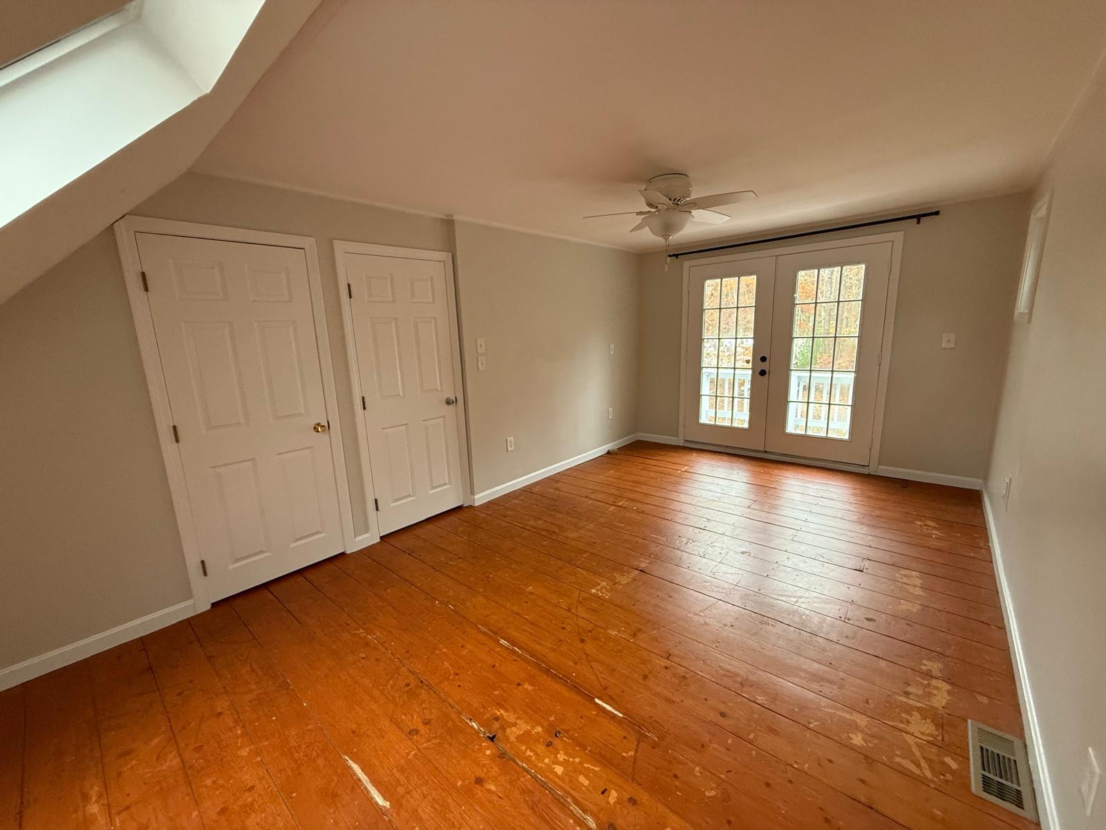 86 Lowell Road Mashpee, MA 02649 - Photo 5 of 18 a view of livingroom with an empty room and wooden floor