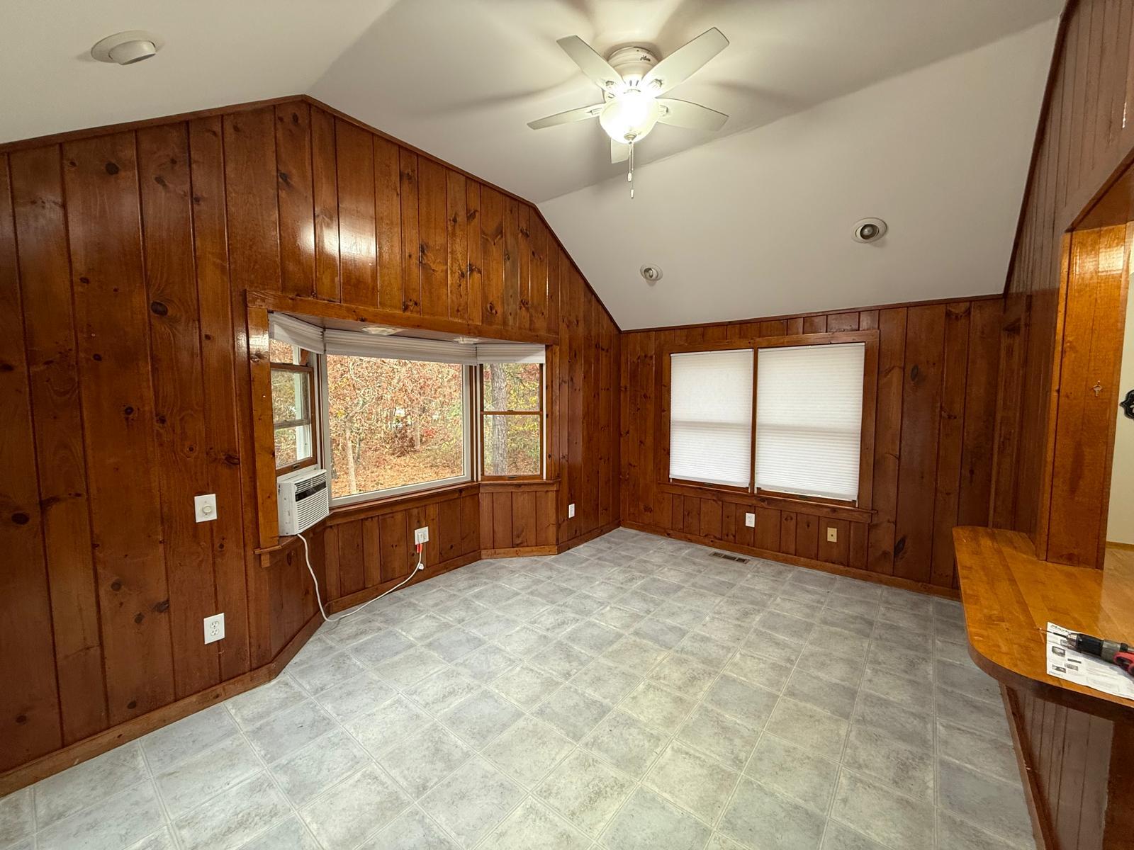 86 Lowell Road Mashpee, MA 02649 - Photo 9 of 18 a view of an empty room with a window and a ceiling fan