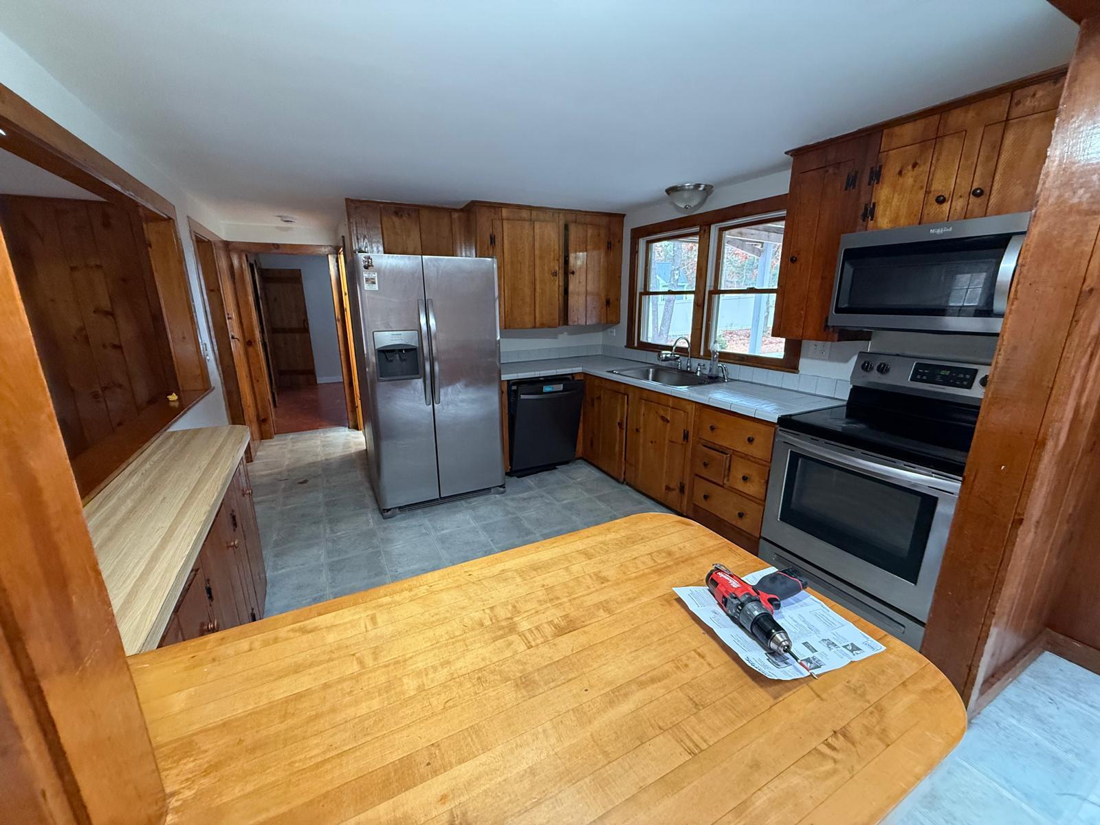 86 Lowell Road Mashpee, MA 02649 - Photo 10 of 18 a kitchen with stainless steel appliances granite countertop a refrigerator stove and oven