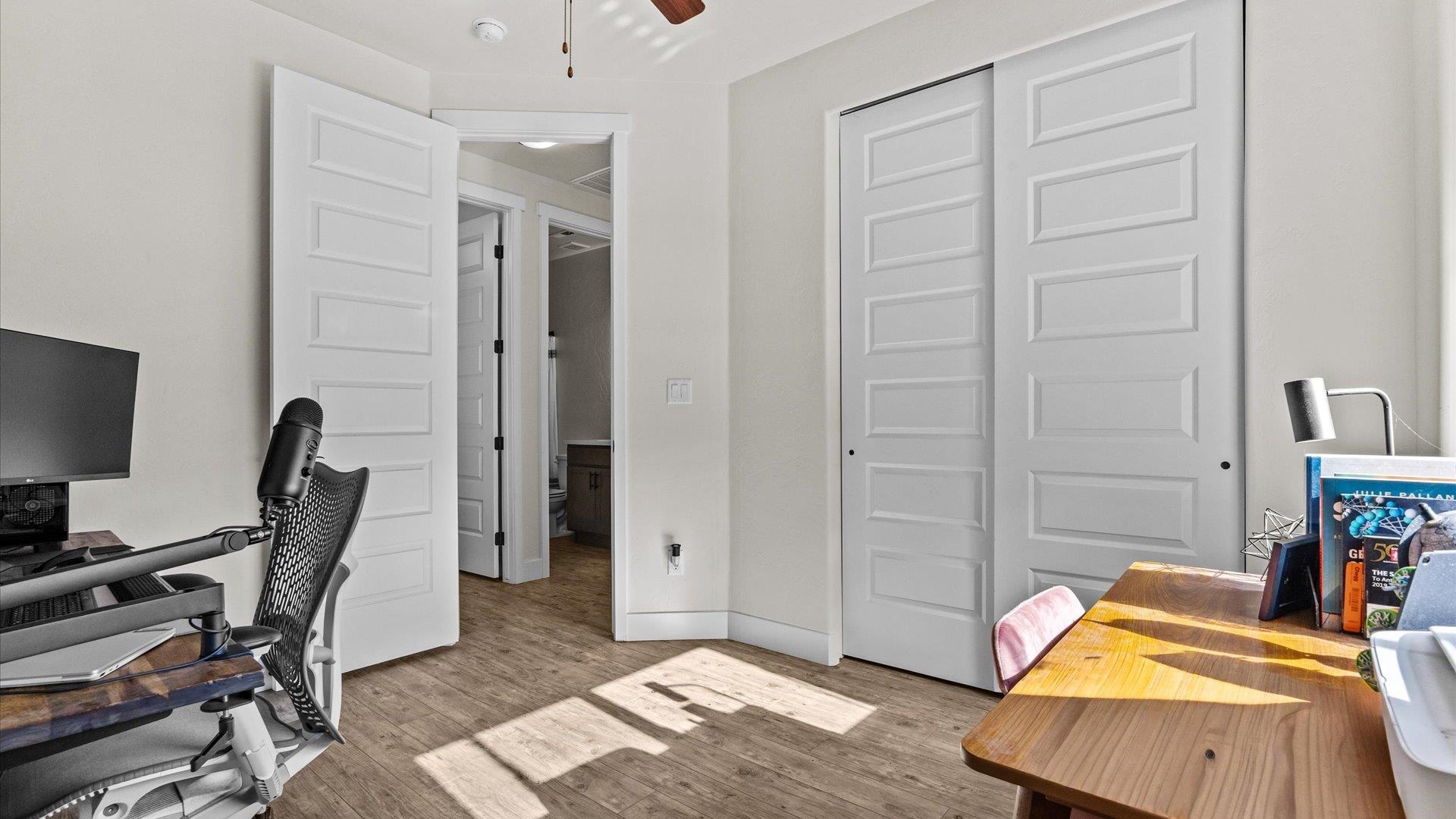 840 Rupp Avenue Palisade, CO 81526 - Photo 22 of 27 a bedroom with furniture and a wooden floor