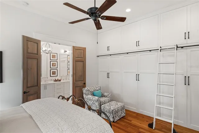 a bedroom with a bed and a chandelier