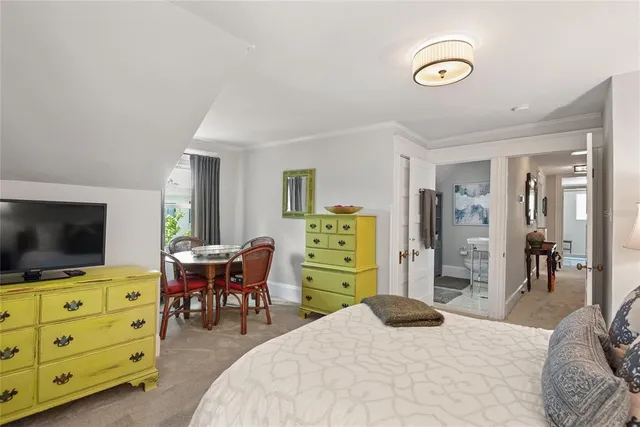 a bedroom with a bed and flat screen tv