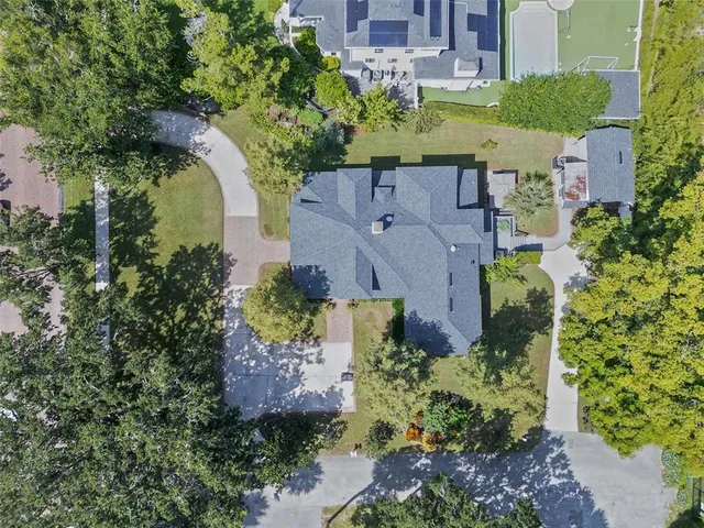 an aerial view of a house with a garden and swimming pool