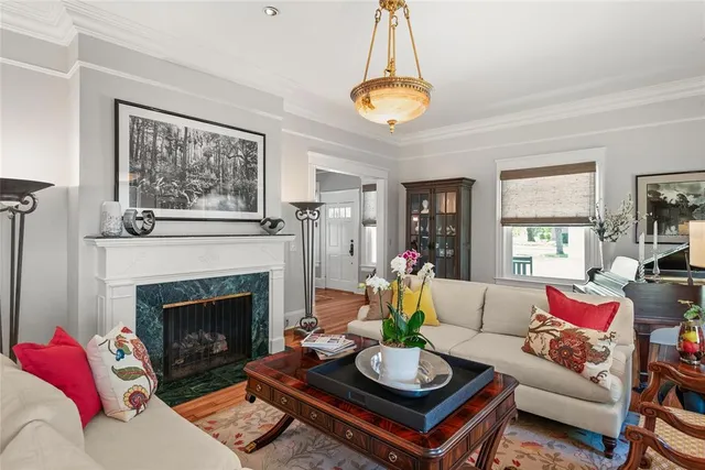 a living room with furniture a chandelier and a fireplace