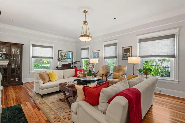 a living room with furniture fireplace and a large window