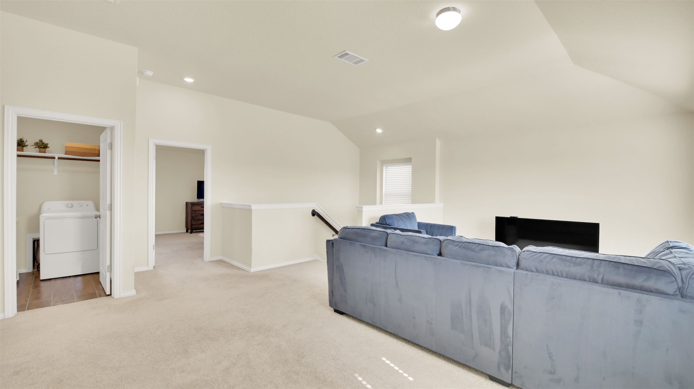 13716 Sugar Bush Path Manor, TX 78653 - Photo 26 of 37 Living area with washer / clothes dryer, light colored carpet, lofted ceiling, and recessed lighting