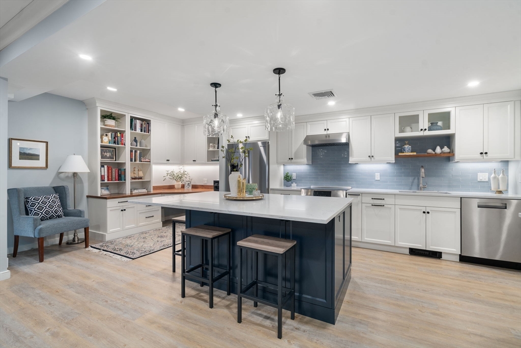 65 Grove Wellesley Ma, Unit 152 Wellesley, MA 02482 - Photo 1 of 16 a kitchen with kitchen island granite countertop lots of counter top space and furniture