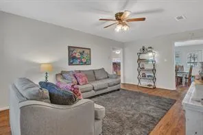 a living room with furniture and kitchen view