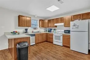 a kitchen with stainless steel appliances granite countertop a refrigerator sink and stove