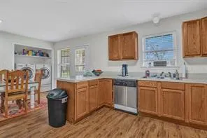 a kitchen with stainless steel appliances granite countertop a sink stove and wooden cabinets