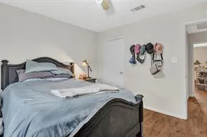 a bedroom with a bed and painting on the wall