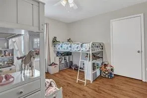 a view of a livingroom with wooden floor and a sink