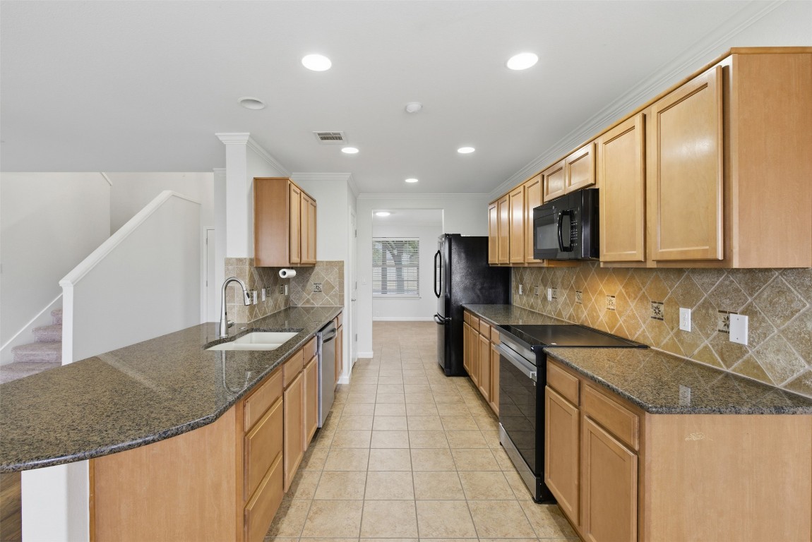 508 Lark Street Leander, TX 78641 - Photo 12 of 40 Smartly designed, with recent oven featuring induction cooktop that is knob free for little ones. Smart sensor faucet at the kitchen sink allows you to keep your hands free.
