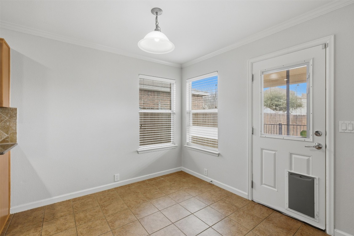 508 Lark Street Leander, TX 78641 - Photo 14 of 40 The breakfast room with door leading to the covered rear porch.