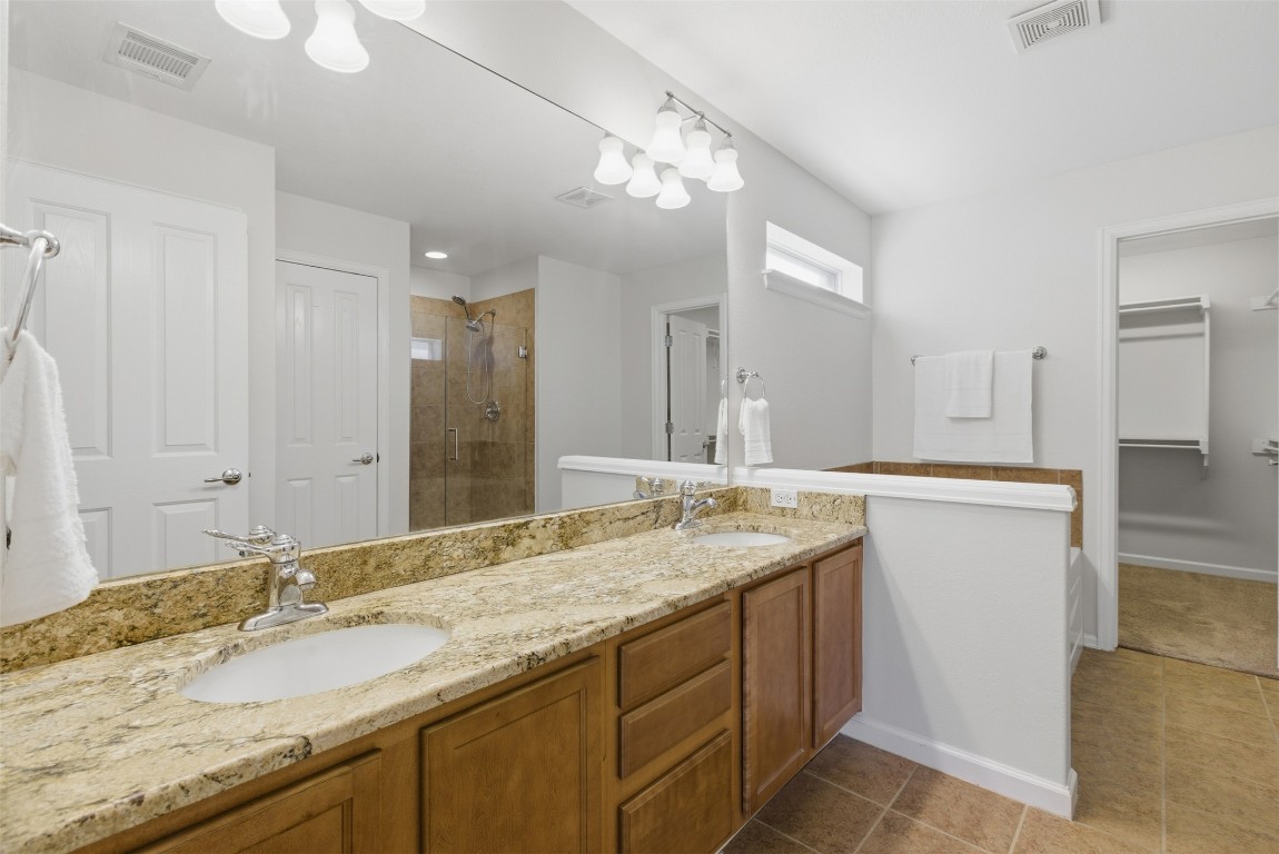 508 Lark Street Leander, TX 78641 - Photo 17 of 40 Granite counters, dual vanities, storage and separate commode area.