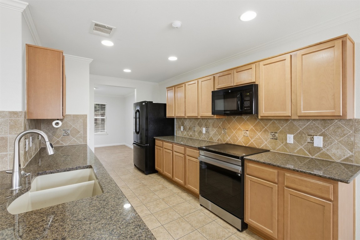 508 Lark Street Leander, TX 78641 - Photo 3 of 40 The kitchen with granite counters is open to the family room.