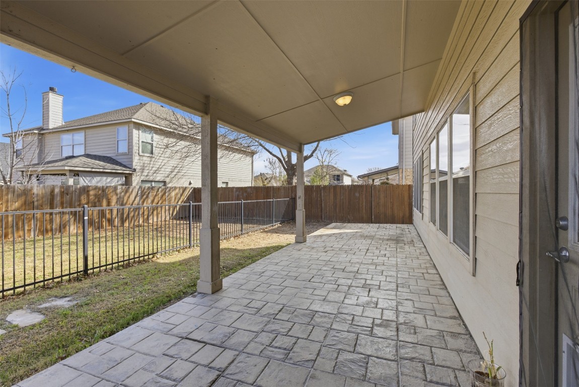 508 Lark Street Leander, TX 78641 - Photo 32 of 40 This covered rear porch has held many memories and provides needed shade. The scored patio runs the length of the home.