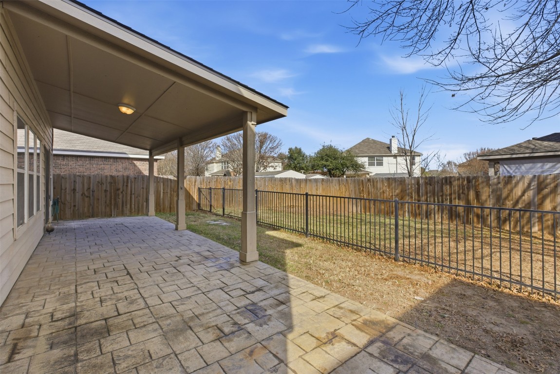 508 Lark Street Leander, TX 78641 - Photo 33 of 40 View of the patio and rear yard. A wrought iron gate creates a separate area for play area, dog run or gardening.