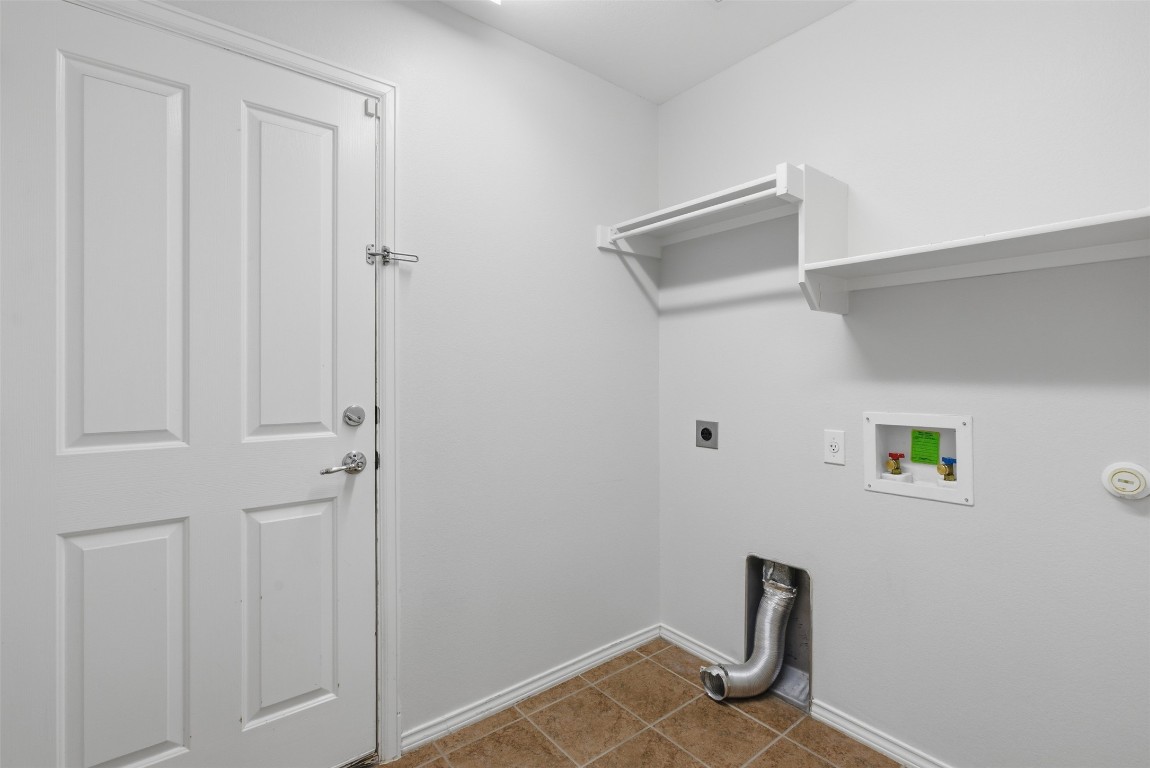 508 Lark Street Leander, TX 78641 - Photo 36 of 40 Laundry room is located downstairs between the garage and downstairs hall area.