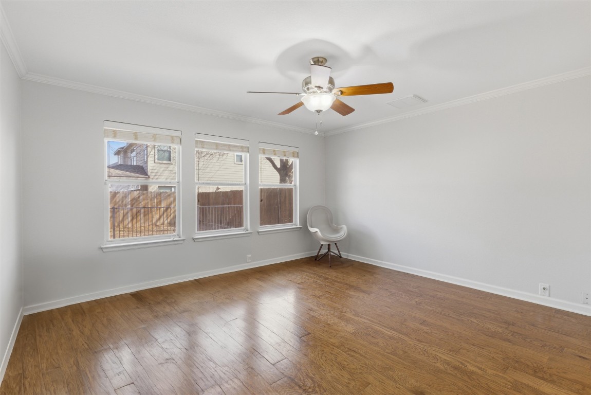 508 Lark Street Leander, TX 78641 - Photo 4 of 40 The primary bedroom, down has wood floors and overlooks the back yard.