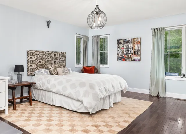 a bedroom with bed and window