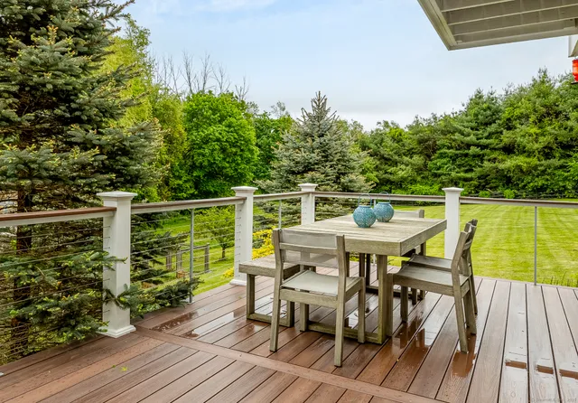 a view of a balcony with table and chairs