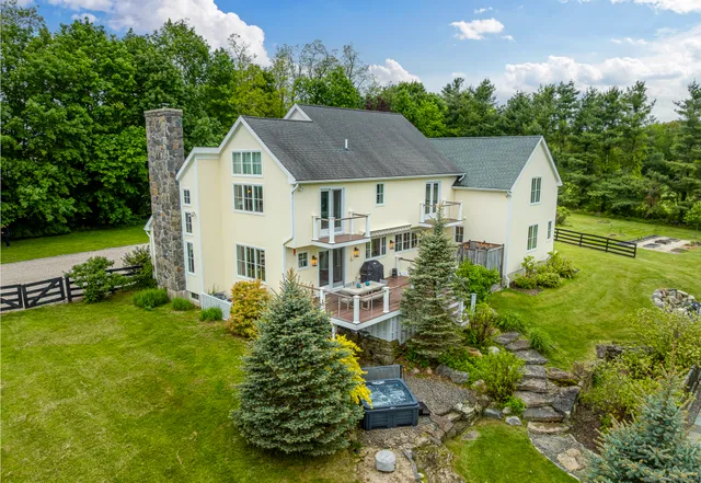 a aerial view of a house with a yard table and chairs