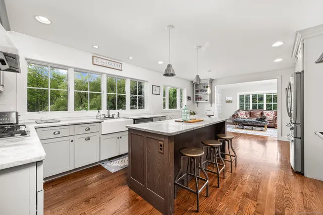 a kitchen with sink stove and wooden floor