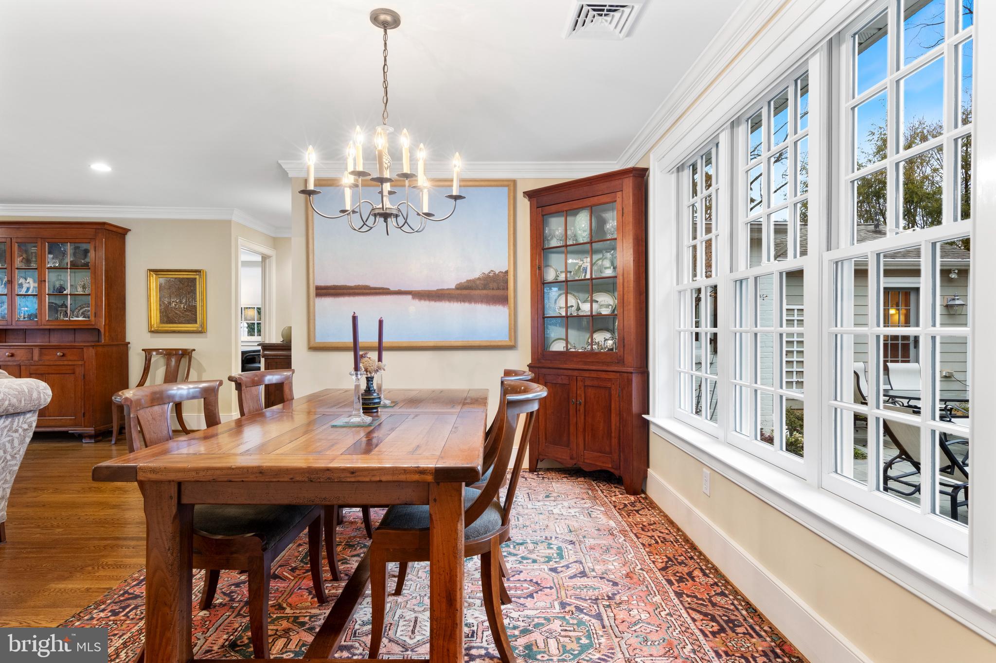 445 Robinwood Road Wayne, PA 19087 - Photo 34 of 57 a dining room with wooden floor a chandelier a wooden table and chairs
