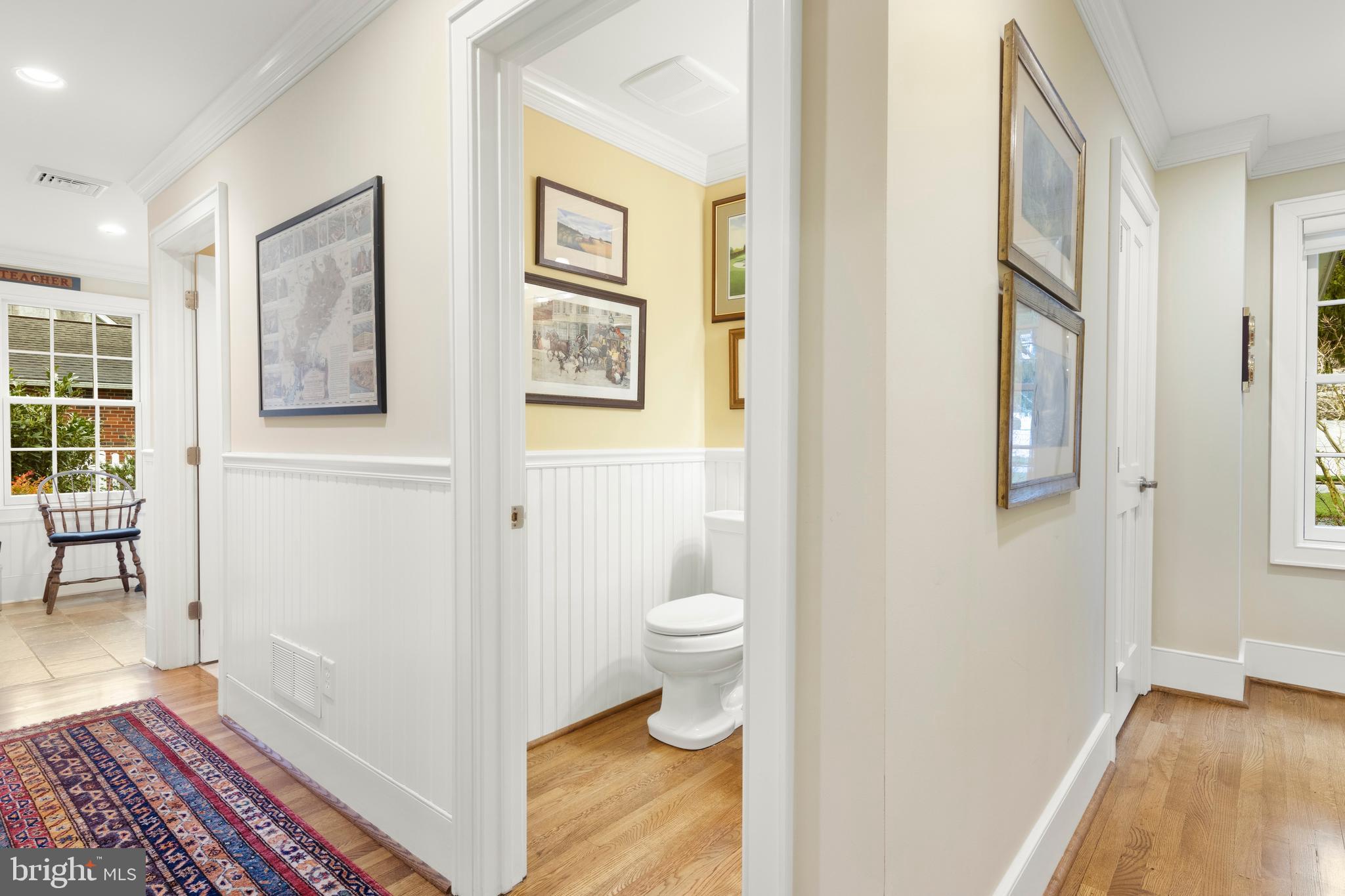 445 Robinwood Road Wayne, PA 19087 - Photo 51 of 57 a view of a hallway with wooden floor and a bathroom