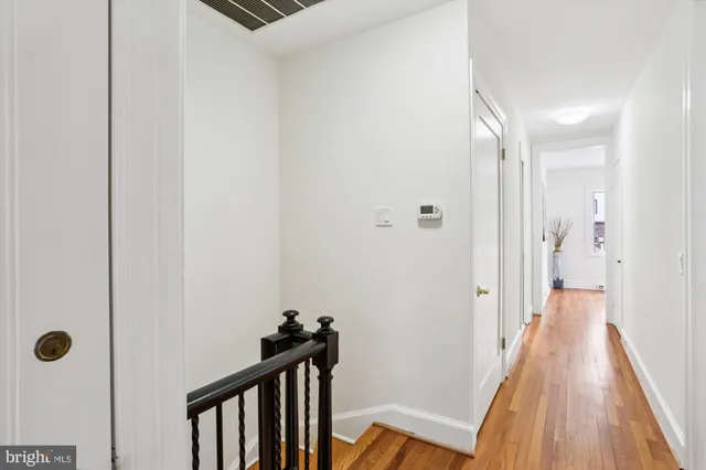 a bedroom with a bed and a potted plant