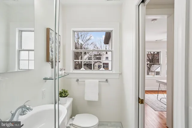 a white toilet sitting next to a bathroom sink
